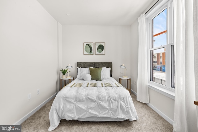 carpeted bedroom featuring multiple windows