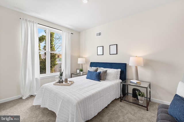 carpeted bedroom with multiple windows