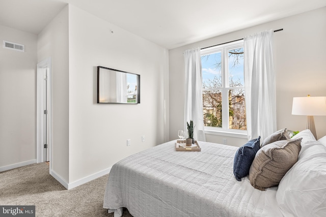 carpeted bedroom with multiple windows