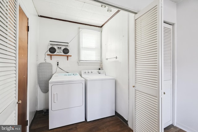 clothes washing area with independent washer and dryer and dark hardwood / wood-style floors