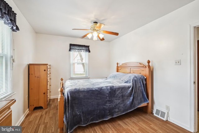 bedroom with ceiling fan and hardwood / wood-style floors