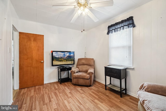 sitting room featuring ceiling fan and light hardwood / wood-style flooring