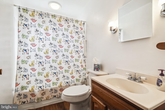 full bathroom with vanity, shower / bath combo, and toilet