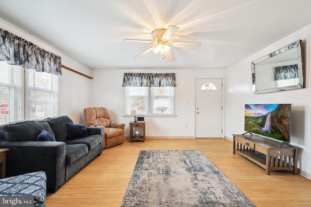 living room featuring hardwood / wood-style floors and ceiling fan