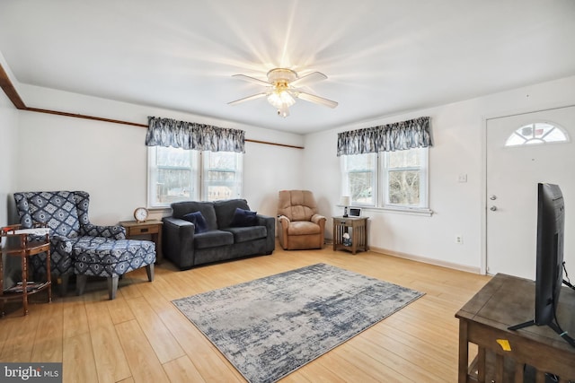 living room with ceiling fan and hardwood / wood-style floors