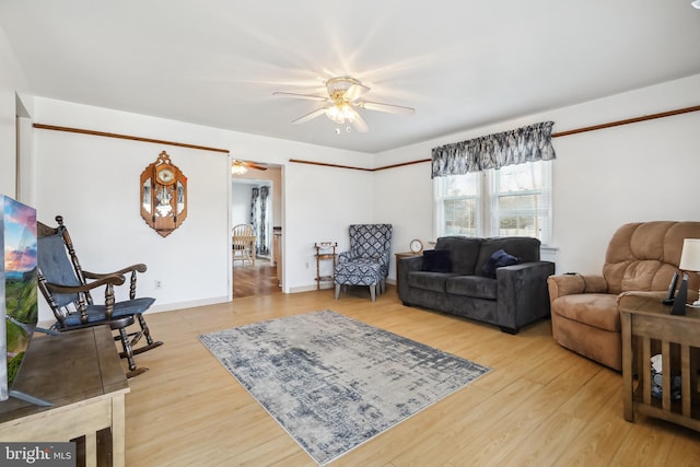 living room featuring hardwood / wood-style flooring and ceiling fan