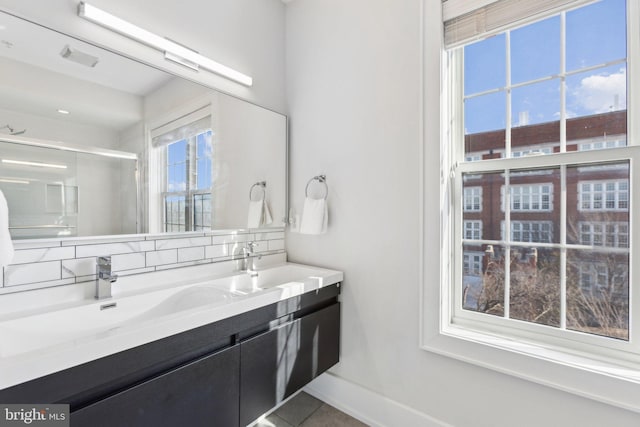 bathroom featuring tile patterned flooring, vanity, and backsplash