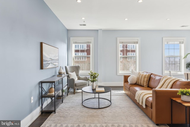 living room with a wealth of natural light and wood-type flooring