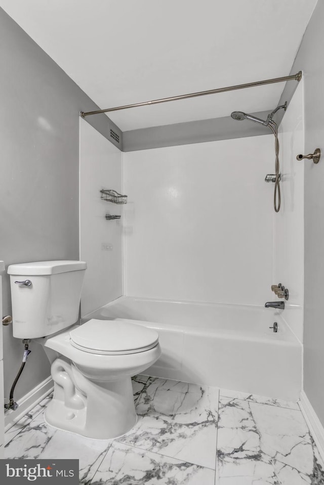 bathroom featuring washtub / shower combination and toilet