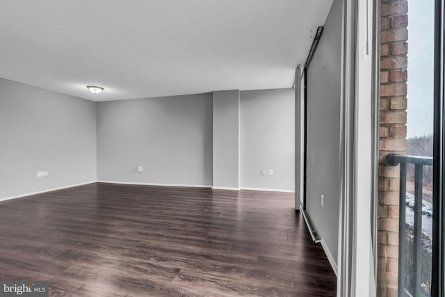 spare room with dark hardwood / wood-style floors