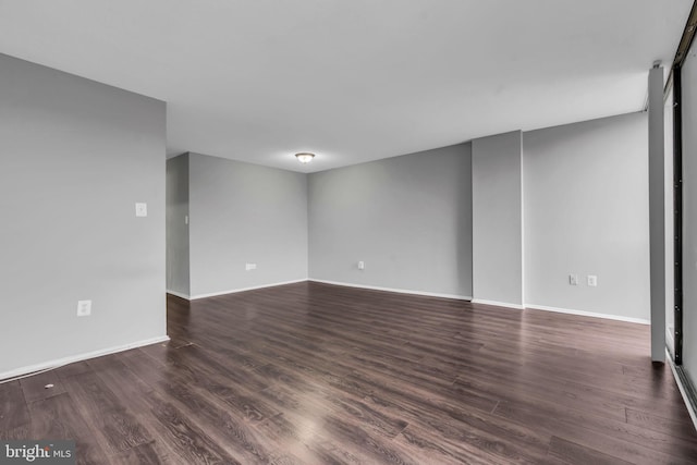 unfurnished room featuring dark wood-type flooring