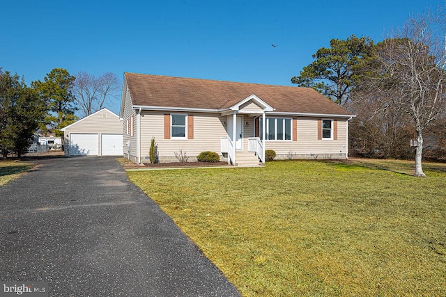 view of front of home with a garage, an outdoor structure, and a front yard