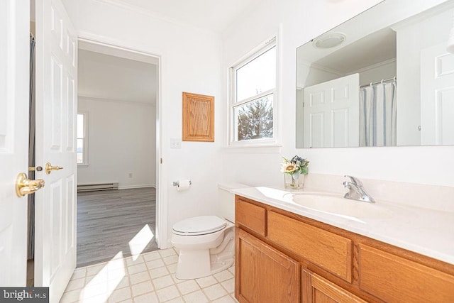 bathroom featuring vanity, a baseboard heating unit, ornamental molding, and toilet