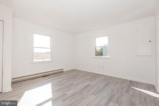 empty room featuring crown molding, a baseboard radiator, light hardwood / wood-style flooring, and a wealth of natural light