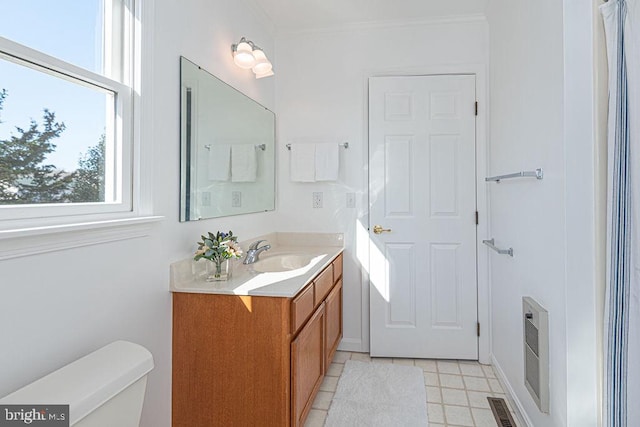 bathroom featuring vanity, crown molding, and toilet