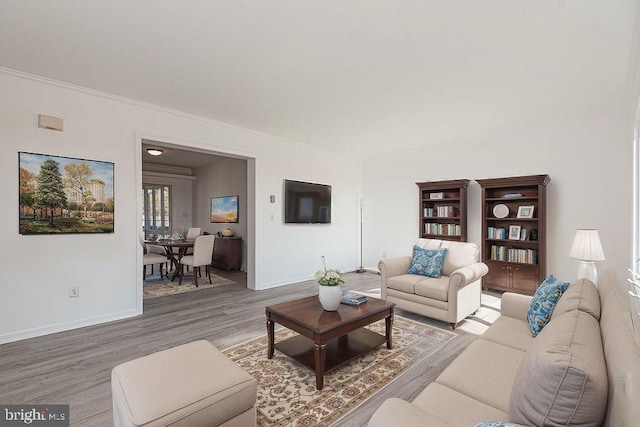 living room featuring crown molding and hardwood / wood-style floors