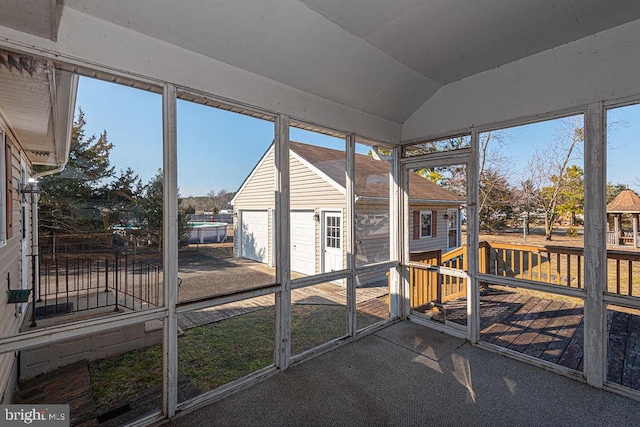 sunroom / solarium featuring lofted ceiling