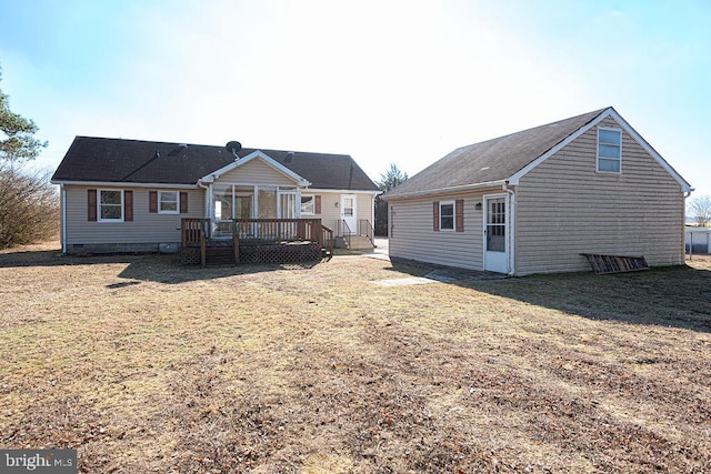 back of property with a wooden deck and a yard