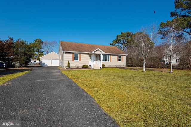 view of front facade featuring a garage, an outdoor structure, and a front lawn