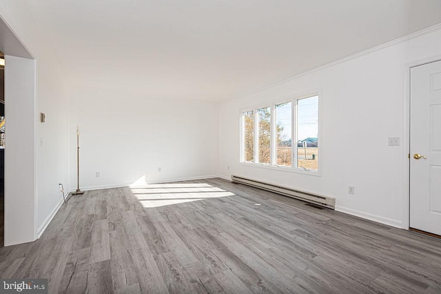 spare room featuring light hardwood / wood-style flooring and baseboard heating