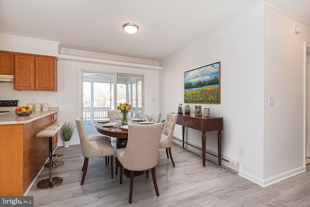 dining room featuring crown molding, light hardwood / wood-style floors, and baseboard heating