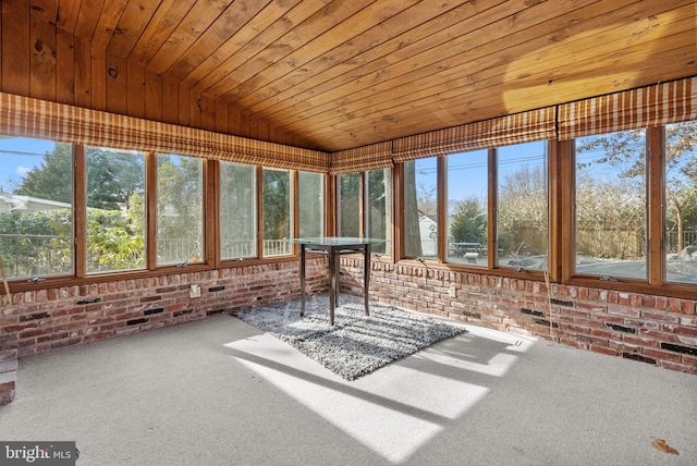 unfurnished sunroom with lofted ceiling and wood ceiling