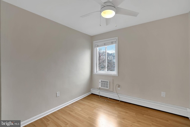 unfurnished room with ceiling fan, baseboard heating, and light hardwood / wood-style flooring