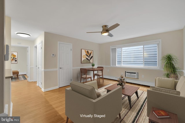 living room featuring ceiling fan, a wall mounted AC, and light hardwood / wood-style floors