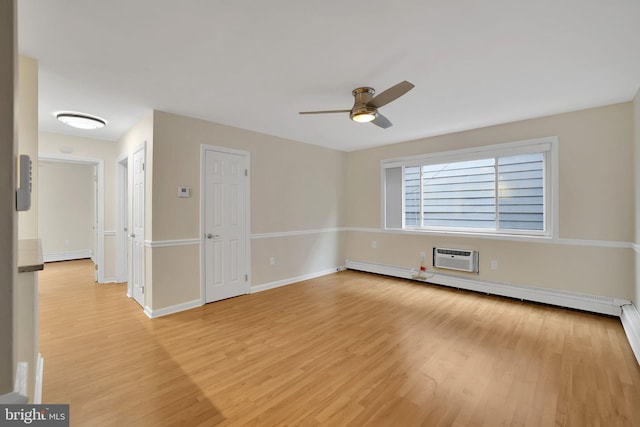 empty room featuring ceiling fan, a wall mounted air conditioner, a baseboard radiator, and light hardwood / wood-style floors