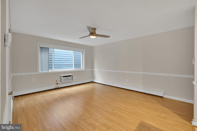 empty room with hardwood / wood-style flooring, a wall mounted air conditioner, and ceiling fan