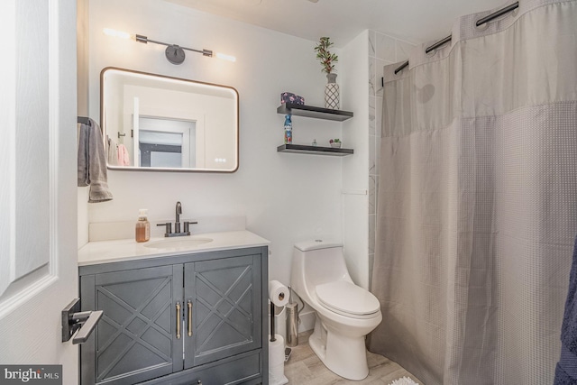 bathroom with vanity, a shower with shower curtain, and toilet