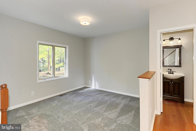 carpeted empty room featuring sink