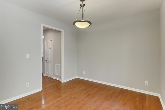 unfurnished room featuring hardwood / wood-style floors