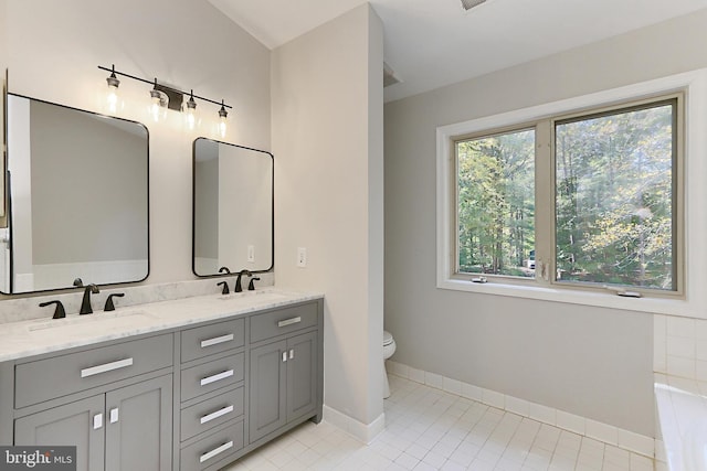 bathroom with vanity, tile patterned floors, and toilet