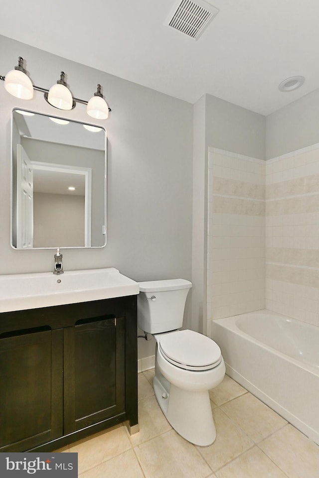 full bathroom with tiled shower / bath, vanity, toilet, and tile patterned flooring