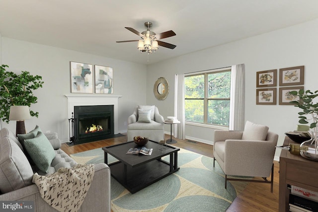 living room with wood-type flooring and ceiling fan