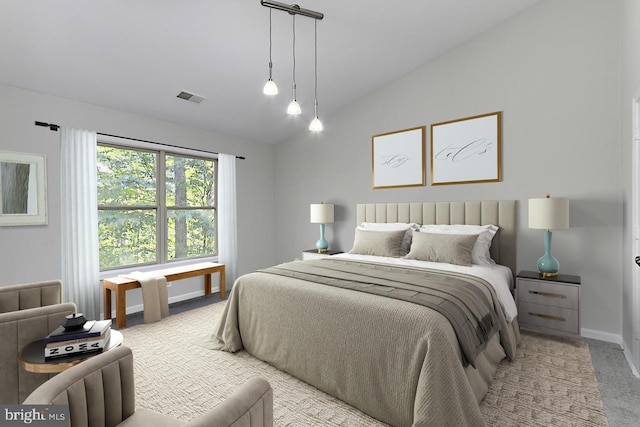 bedroom with lofted ceiling and light carpet