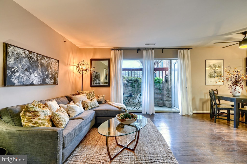 living room featuring ceiling fan and hardwood / wood-style floors