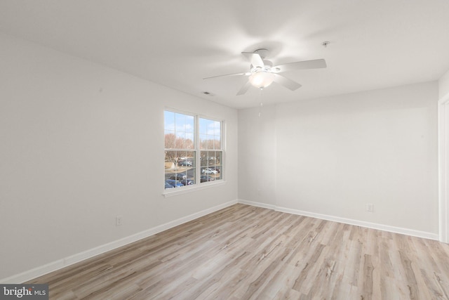 spare room featuring light hardwood / wood-style floors and ceiling fan