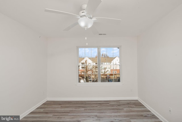 spare room with hardwood / wood-style flooring and ceiling fan