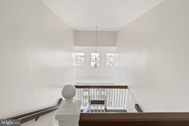 staircase featuring a chandelier