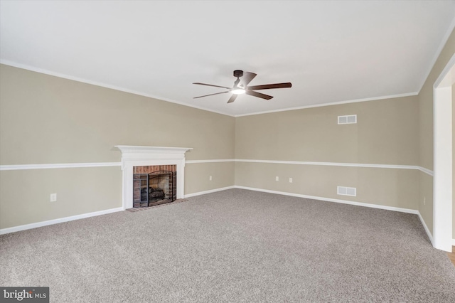 unfurnished living room with ornamental molding, carpet floors, ceiling fan, and a fireplace