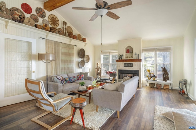 living room featuring lofted ceiling with beams, ceiling fan, dark hardwood / wood-style floors, and a fireplace