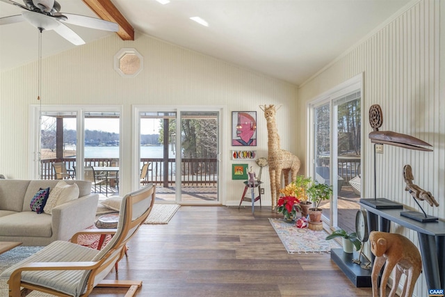 sunroom / solarium featuring vaulted ceiling with beams, ceiling fan, and a water view