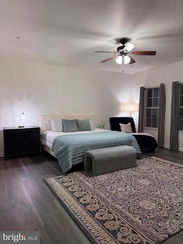 bedroom with ceiling fan and dark hardwood / wood-style flooring