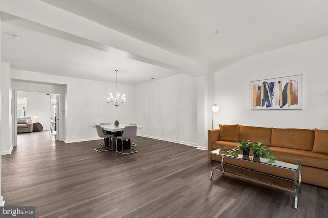 living room featuring an inviting chandelier and dark hardwood / wood-style flooring