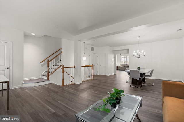 living room with dark hardwood / wood-style flooring and a chandelier