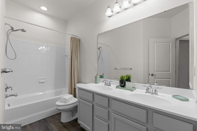 full bathroom with wood-type flooring, toilet, vanity, and shower / bath combo with shower curtain