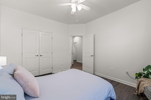 bedroom with dark wood-type flooring, a closet, and ceiling fan