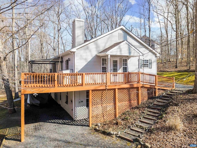 back of house featuring a deck